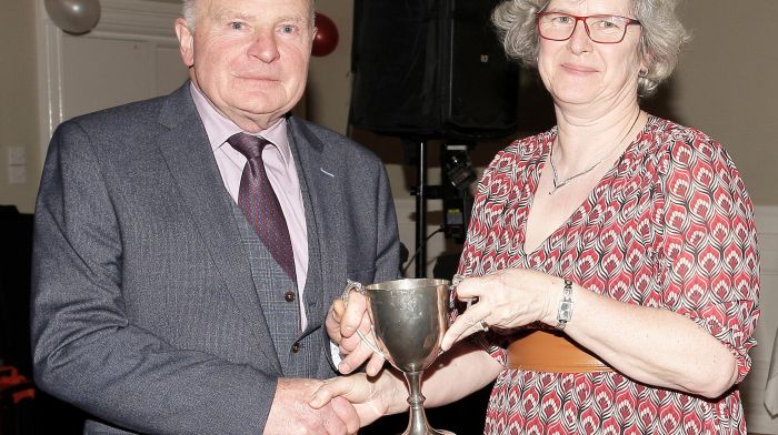 Kay Russell presents the Michael Ahern Memorial Cup to the Club Person of the Year JJ Walsh.