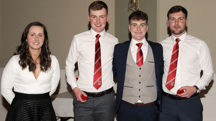 Martina O'Brien presents the 2022 SW junior A hurling championship medals to the Ryan brothers Cian, Aaron and Sean.