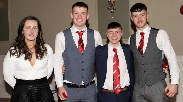 Martina O'Brien presents the 2022 SW junior A hurling championship medals to Ciarán O'Neill, Keith Nyhan and Tadhg O'Neill.