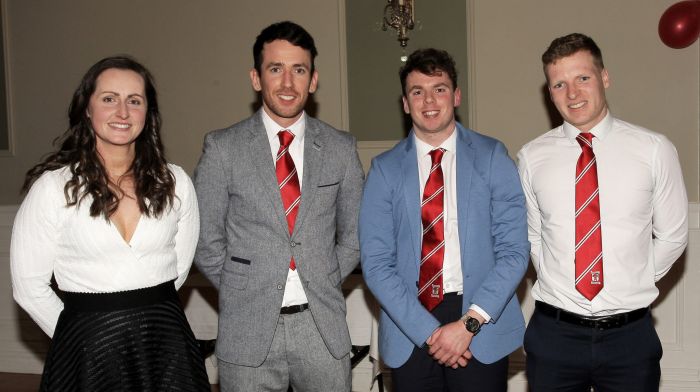 Martina O'Brien presents the 2022 SW junior A hurling championship medals to Seamus McCarthy, Cormac McCarthy and Gearoid O'Leary.