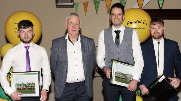 Conor Counihan presenting medals to David Collins, Eoin Murray and Daniel O'Sullivan.