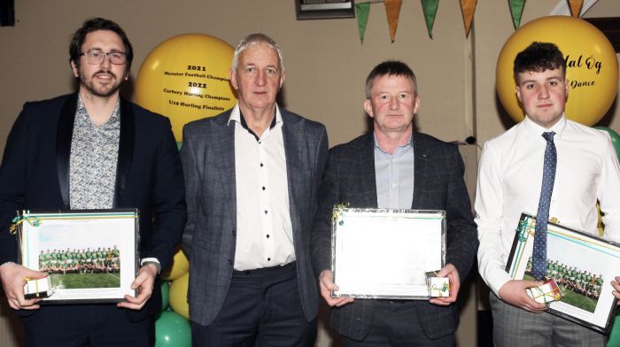 Project Co-Ordinator Cork Football, Conor Counihan, presenting medals to Sam Kingston, Cathal Duggan and Padraig Galvin.