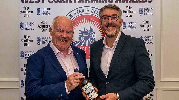 Former Southern Star editor Con Downing receives an award from Southern Star managing director Seán Mahon.