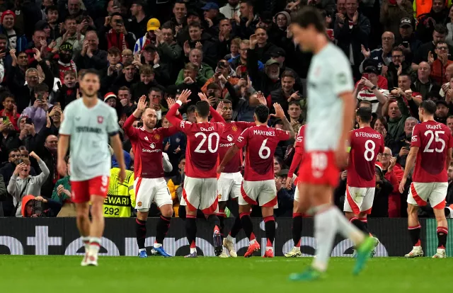 Manchester United's players celebrate with Christian Eriksen, second left, after he opened the scoring 