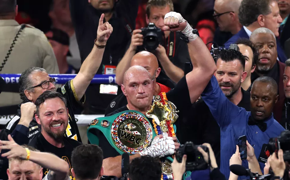 Tyson Fury, centre, holds the WBC heavyweight title (Bradley Collyer/PA)