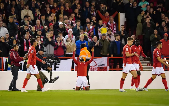 Emmanuel Dennis (centre) celebrates opening the scoring