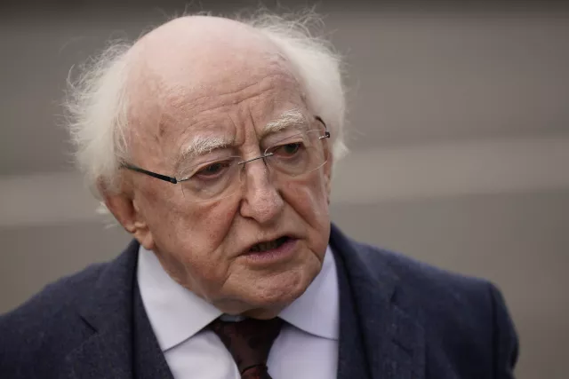 Irish President Michael D. Higgins speaks to the media as he leaves the funeral