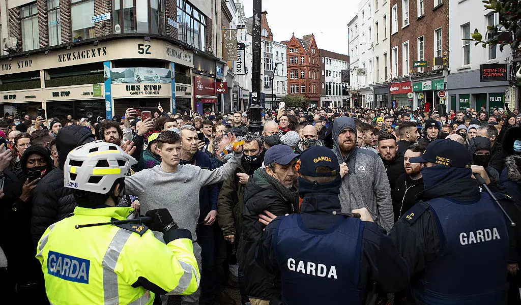 Gardai talk to protesters during an anti-lockdown protest in Dublin city centre