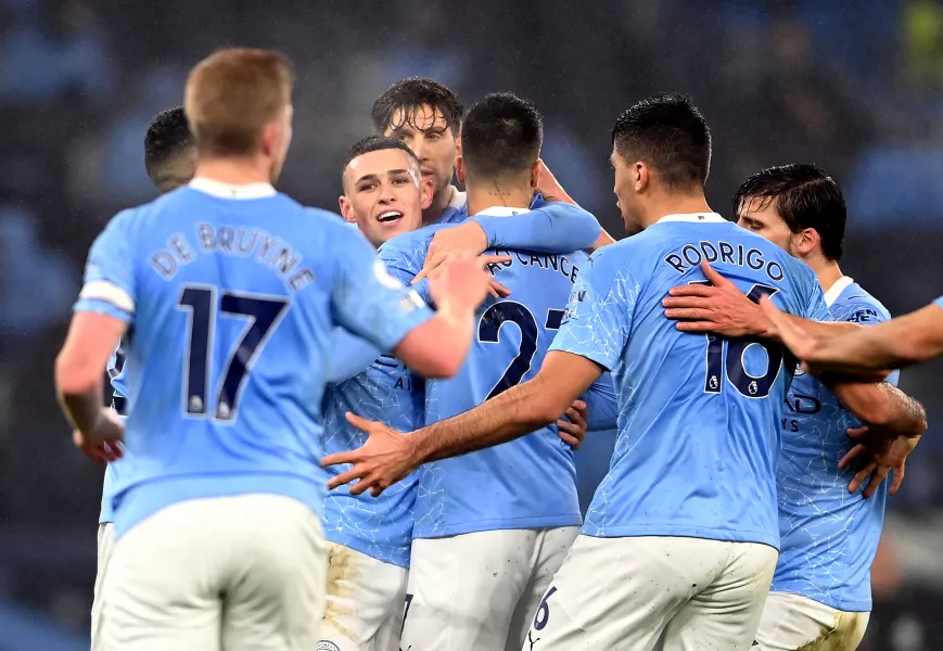 Manchester City players gather to celebrate Phil Foden's goal against Brighton on Wednesday evening