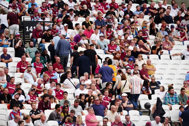 Fans leave the London Stadium early, with plenty of empty seats, as West Ham lose 3-0 to Chelsea. 