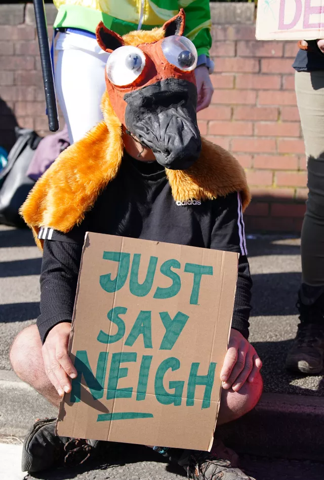 An activist outside the Aintree Racecourse