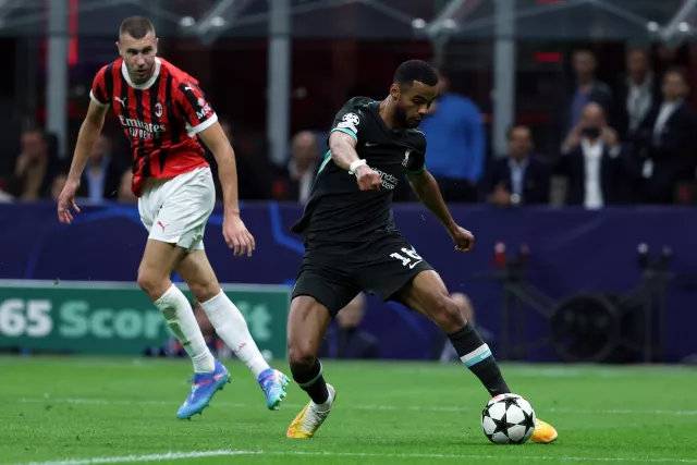 Liverpool’s Cody Gakpo, right, dribbles clear of AC Milan's Strahinja Pavlovic