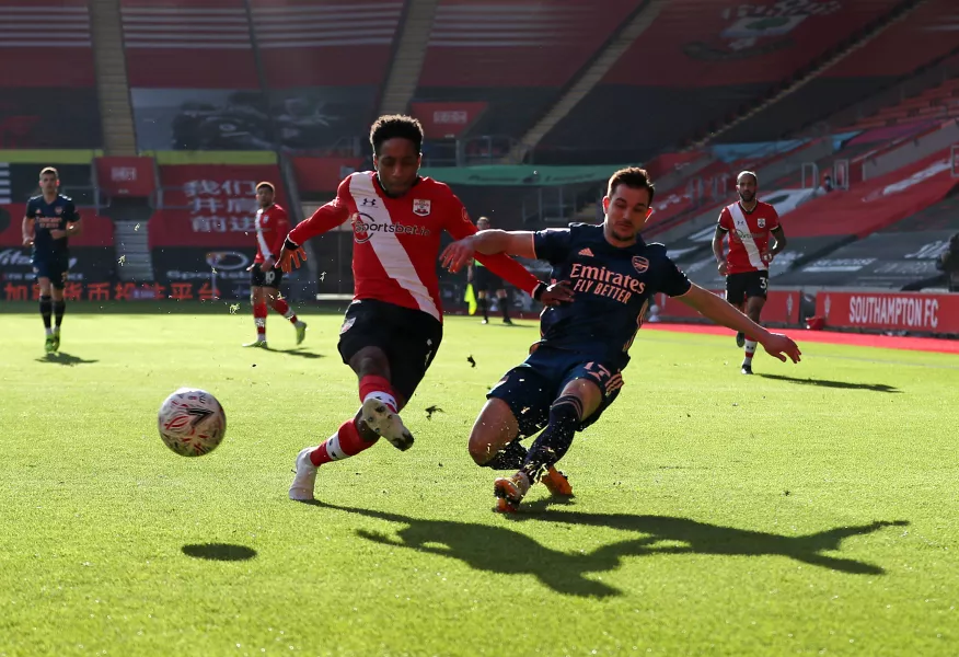 Kyle Walker-Peters battles for the ball with Cedric