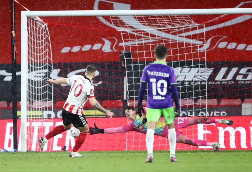 Billy Sharp's penalty took Sheffield United to the sixth round.