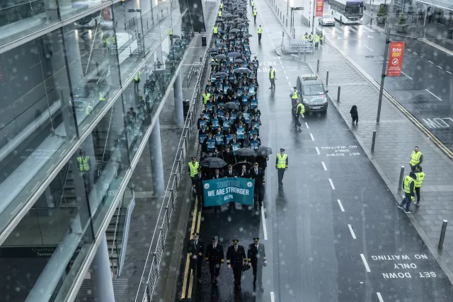 Aer Lingus pilots marching around Dublin Airport in the rain