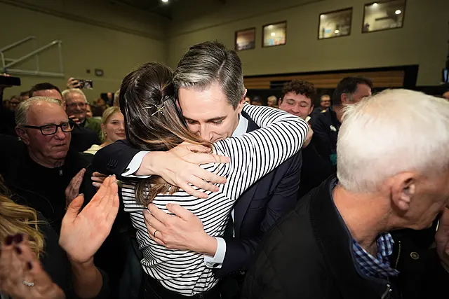 Simon Harris is hugged by his wife after being re-elected