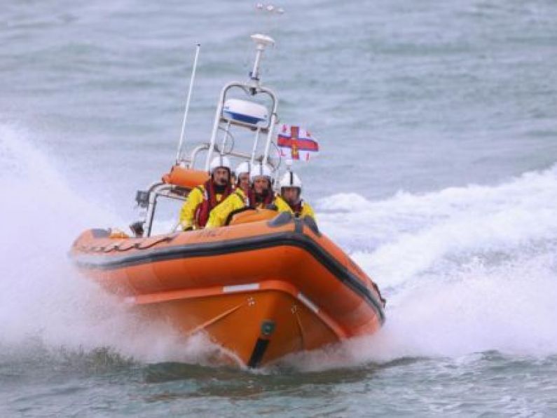 Helvick Lifeboat assists in bringing crewman to safety.
